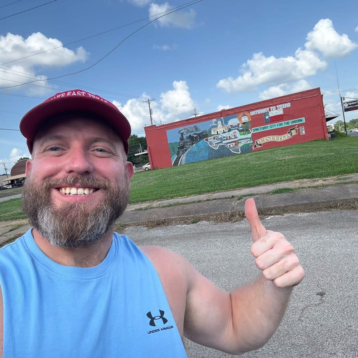 Ryan Nichols in East Texas, smiling with a thumbs up
