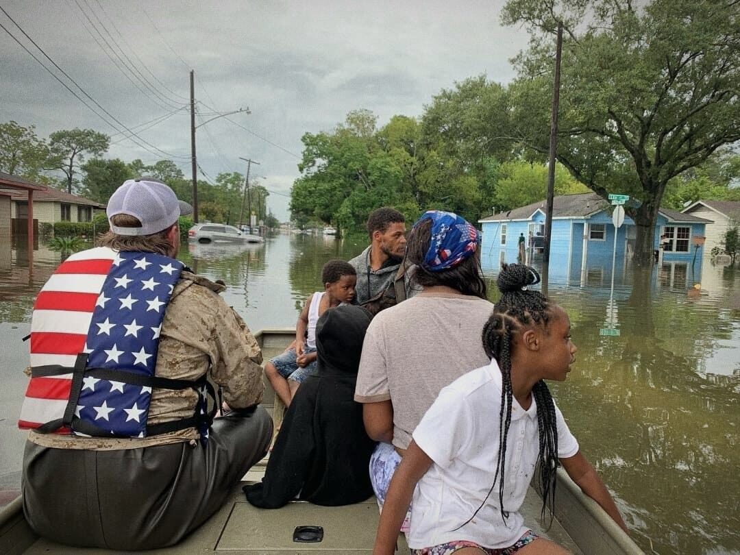 Ryan's boat carrying families out of a flooded neighborhood